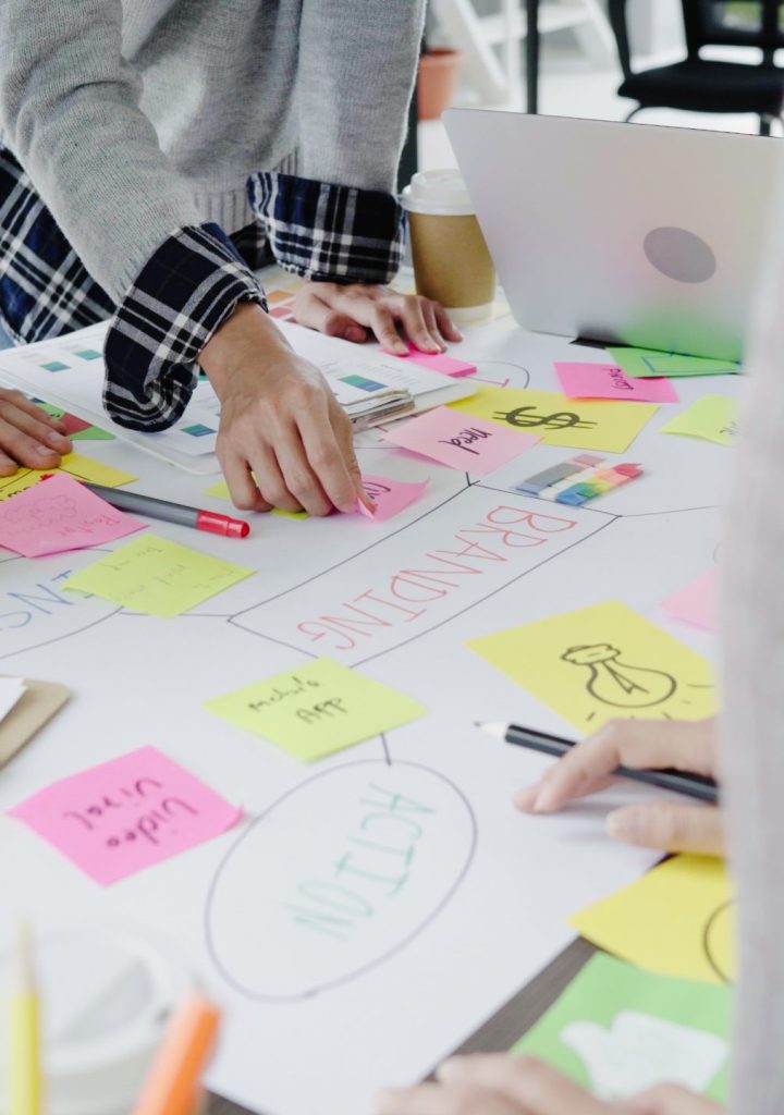 Group of casually dressed business people discussing ideas in the office. Creative professionals gathered at the meeting table for discuss the important issues of the new successful startup project.
